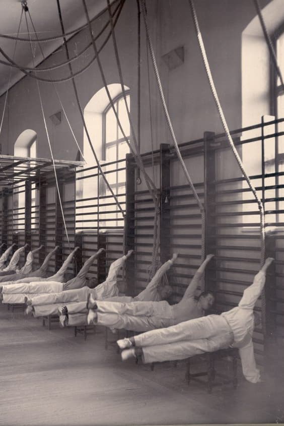 Historical photo of Swedish ladders with multiple men exercising