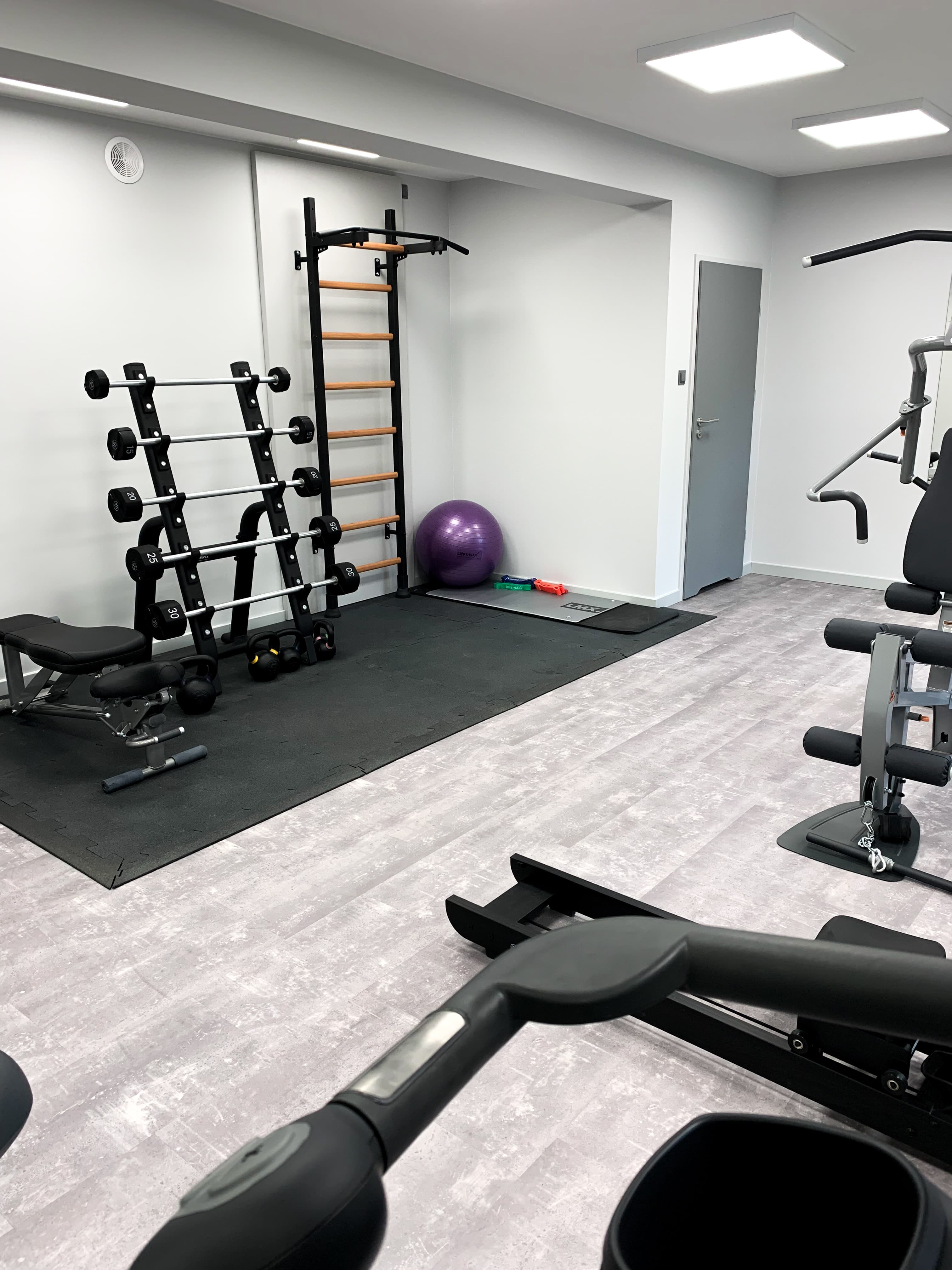 Clean small fitness studio with BenchK