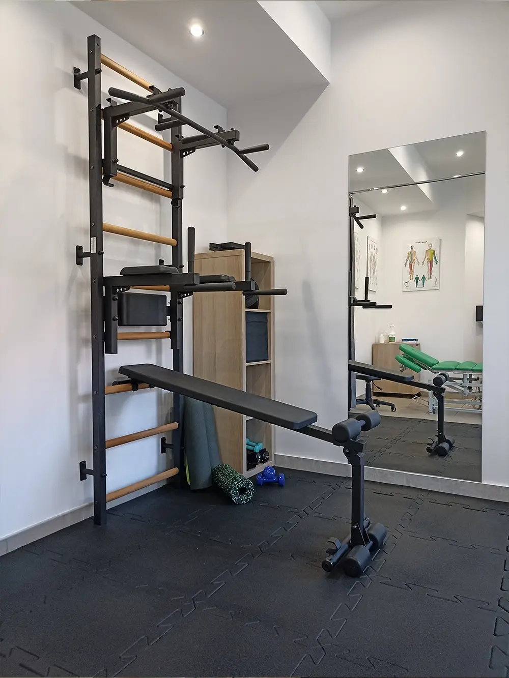 Padded floor gym with mirror and BenchK wall station