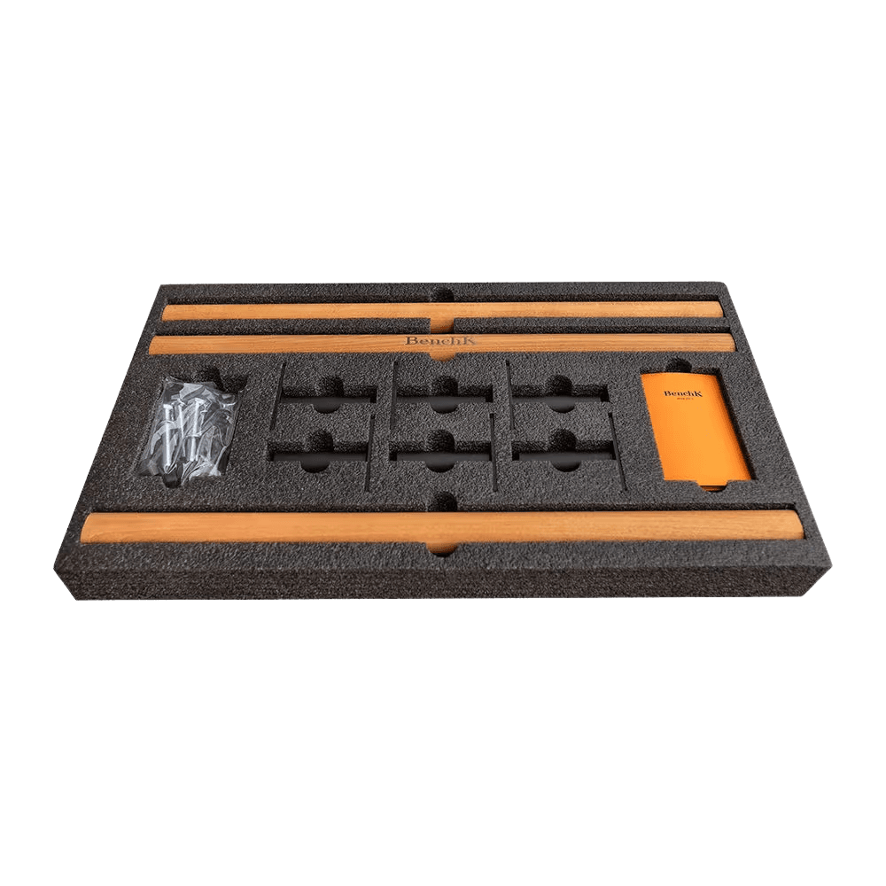 BenchK 700-series materials laid out — European beech rungs, powder-coated steel frame, polyurethane padding, assembly hardware